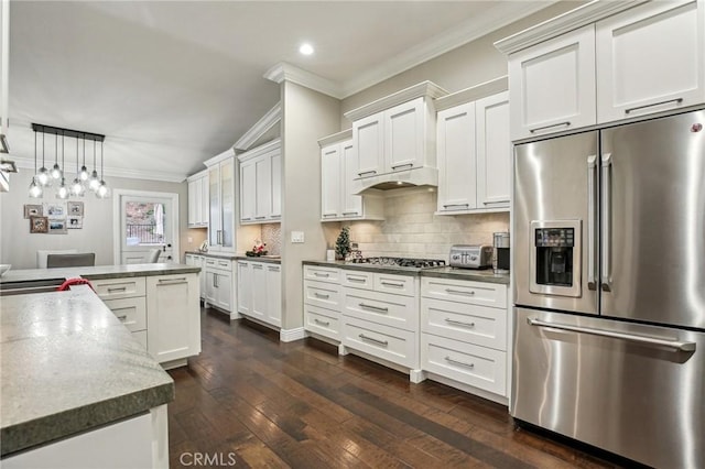 kitchen with white cabinets, decorative light fixtures, dark wood-type flooring, and appliances with stainless steel finishes