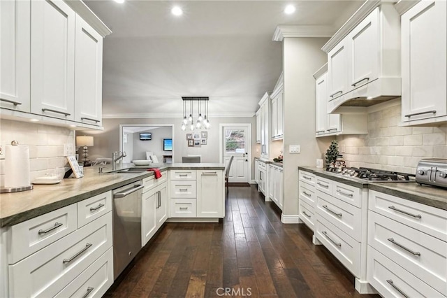 kitchen with pendant lighting, dark wood-type flooring, white cabinets, kitchen peninsula, and stainless steel appliances