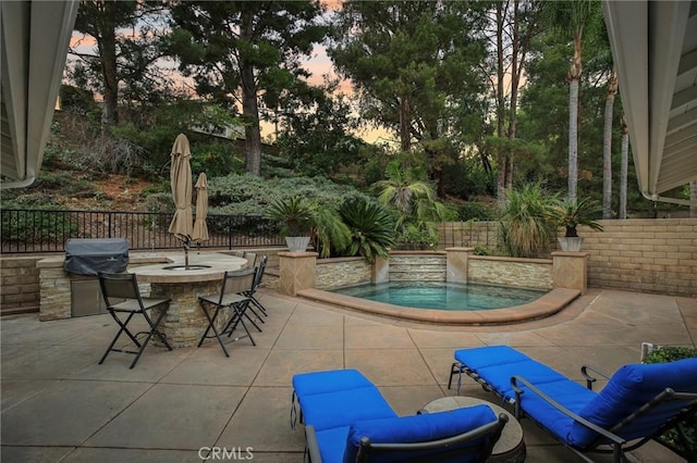 patio terrace at dusk with exterior bar