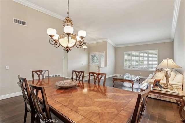 dining room featuring dark hardwood / wood-style flooring, a chandelier, and ornamental molding