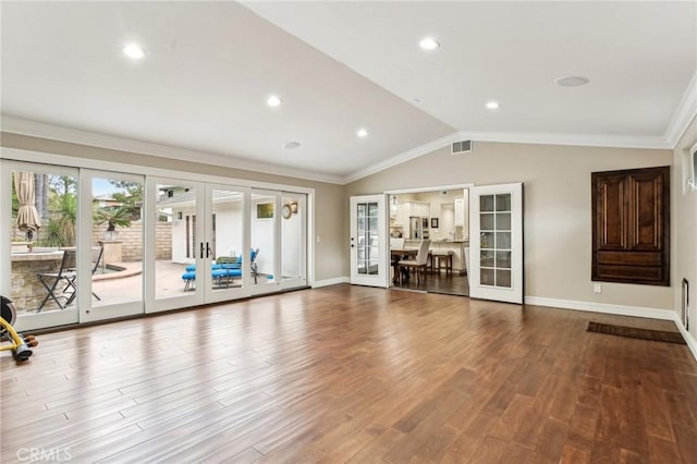 workout room featuring crown molding, french doors, hardwood / wood-style floors, and vaulted ceiling