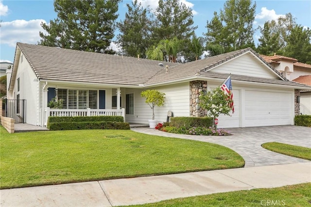 single story home with a porch, a garage, and a front lawn