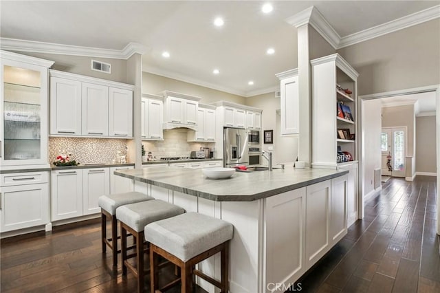 kitchen with white cabinets, dark hardwood / wood-style flooring, and crown molding