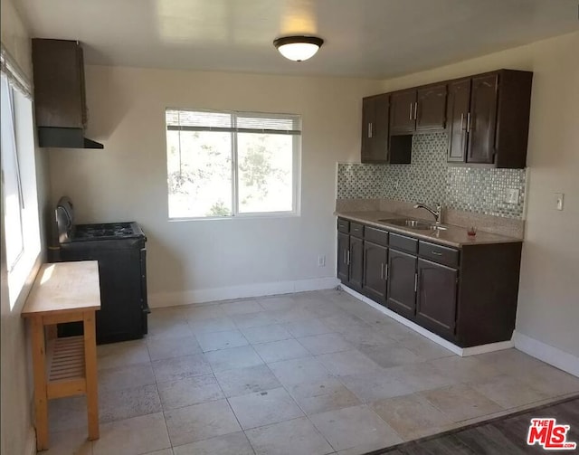 kitchen with tasteful backsplash, dark brown cabinets, black electric range oven, and sink