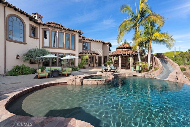 view of pool with a gazebo, a patio area, an in ground hot tub, and an outdoor living space