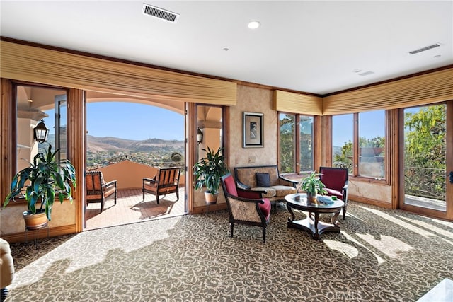 living room with a mountain view and carpet floors