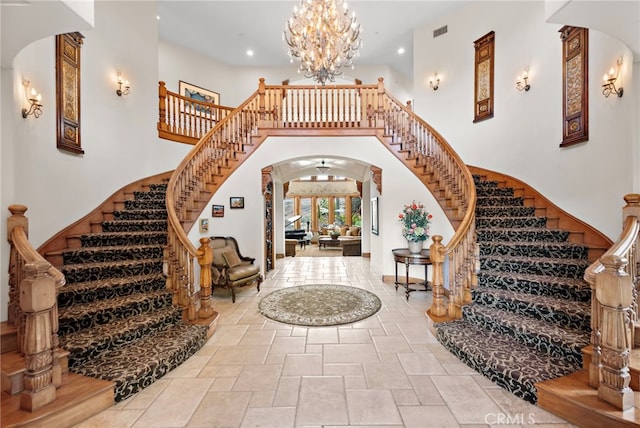 entryway with a notable chandelier and a towering ceiling