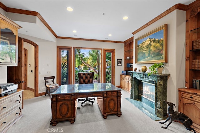 office space with light carpet, a premium fireplace, and ornamental molding