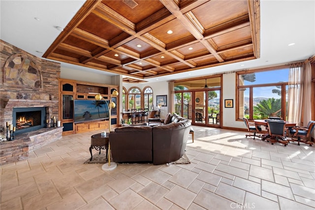 living room with a fireplace, french doors, beamed ceiling, and coffered ceiling