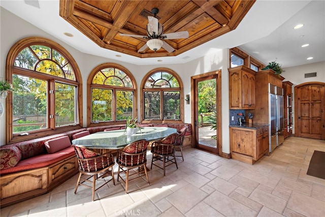 dining room with ceiling fan, a healthy amount of sunlight, coffered ceiling, and wooden ceiling