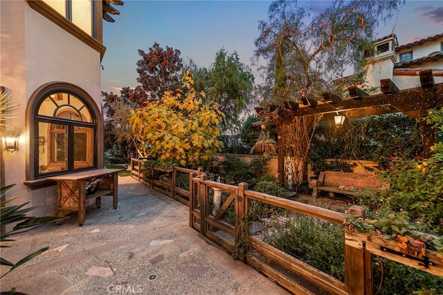 patio terrace at dusk with a pergola