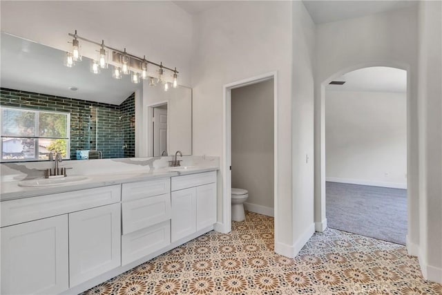 bathroom featuring tile patterned flooring, a shower with door, vanity, and toilet