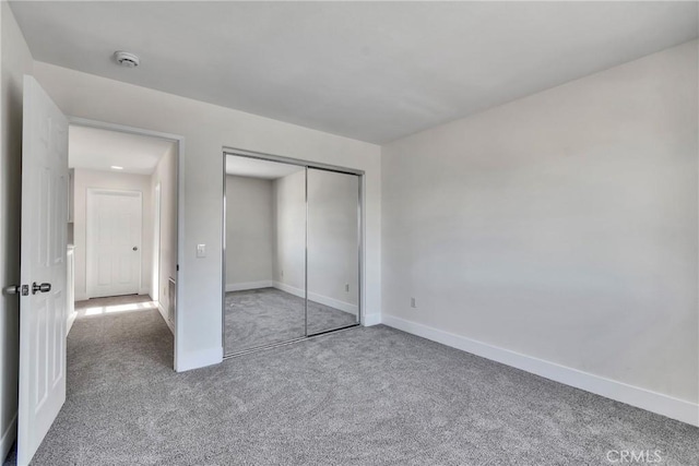 unfurnished bedroom featuring a closet and carpet