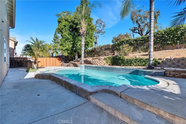 view of swimming pool with a patio area