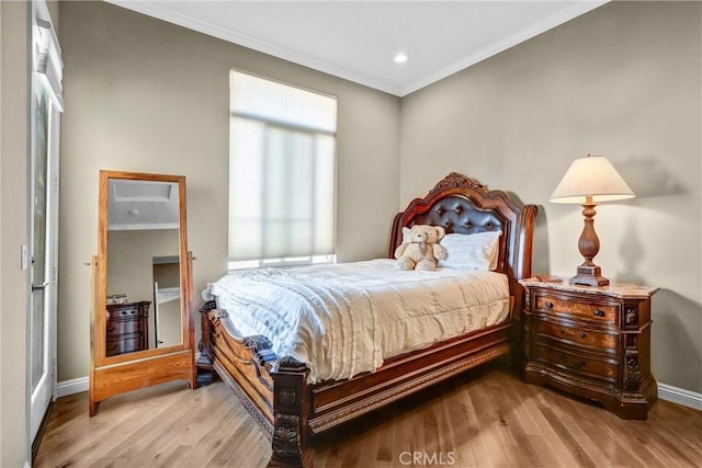 bedroom featuring crown molding and hardwood / wood-style floors