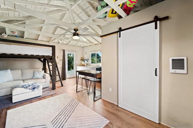 bedroom featuring wood ceiling, a barn door, lofted ceiling with beams, and hardwood / wood-style flooring