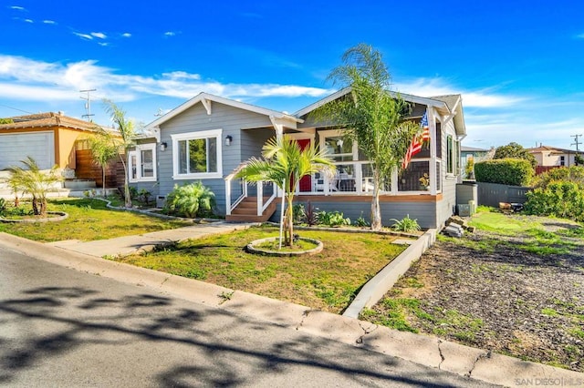 view of front of property with a porch and a front lawn