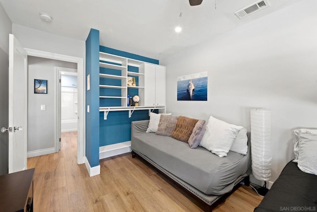 living room with ceiling fan and light hardwood / wood-style floors