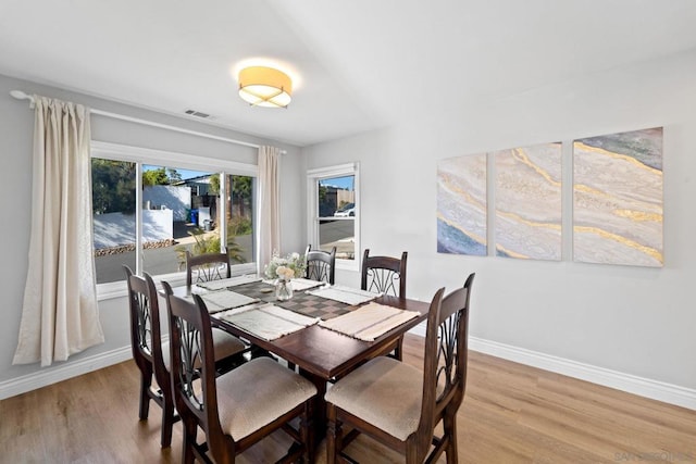 dining space with light wood-type flooring