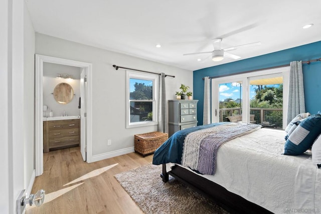 bedroom with ceiling fan, light hardwood / wood-style flooring, connected bathroom, and multiple windows