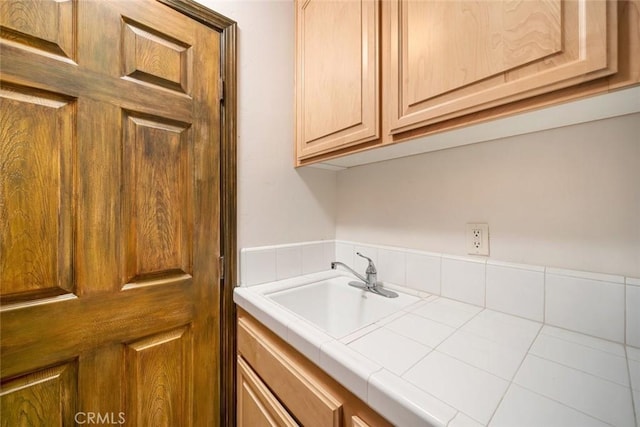 clothes washing area featuring sink