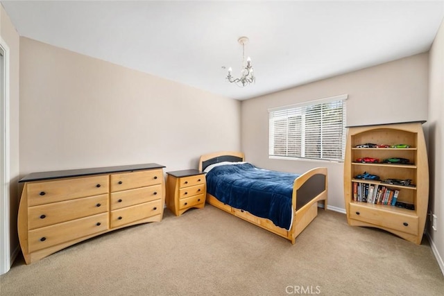 carpeted bedroom featuring a notable chandelier