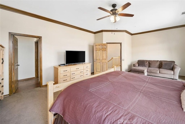 bedroom featuring crown molding, carpet floors, and ceiling fan