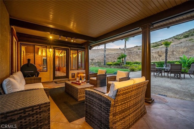 view of patio / terrace with a mountain view and an outdoor hangout area