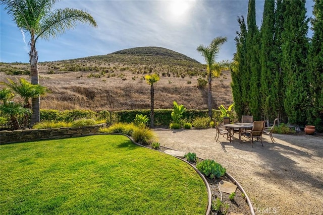 view of yard with a patio and a mountain view