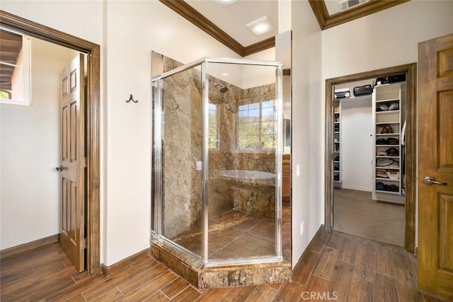 bathroom with ornamental molding and an enclosed shower