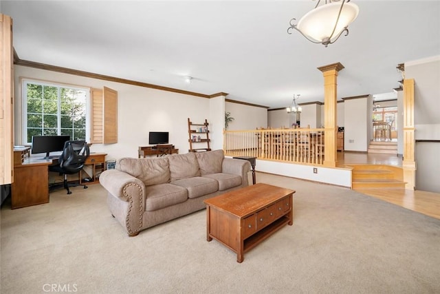 carpeted living room featuring ornamental molding, decorative columns, and a notable chandelier