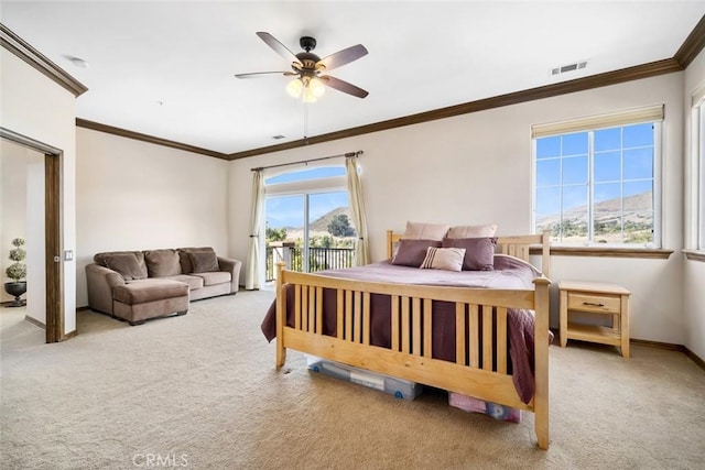 carpeted bedroom with crown molding, a mountain view, access to outside, and ceiling fan