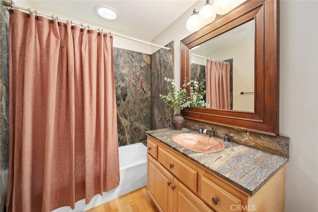 bathroom with vanity, hardwood / wood-style floors, and shower / bath combo with shower curtain