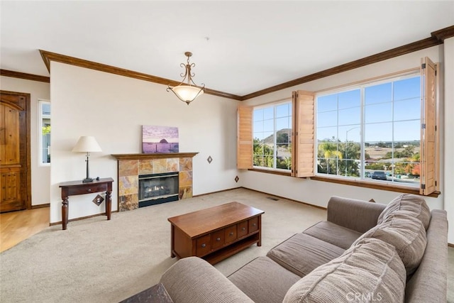 carpeted living room with crown molding and a fireplace