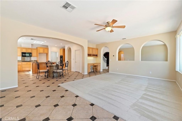 interior space with ceiling fan