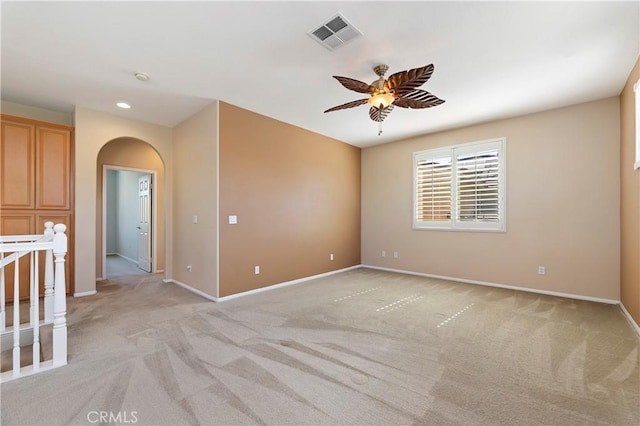 carpeted spare room with ceiling fan