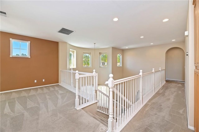 hallway with light colored carpet