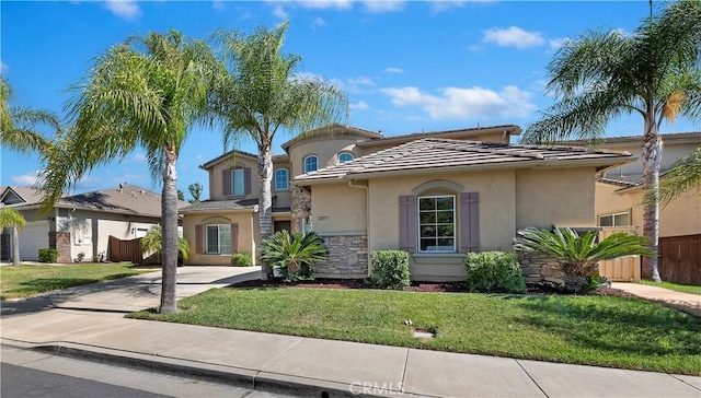 mediterranean / spanish house with a front lawn