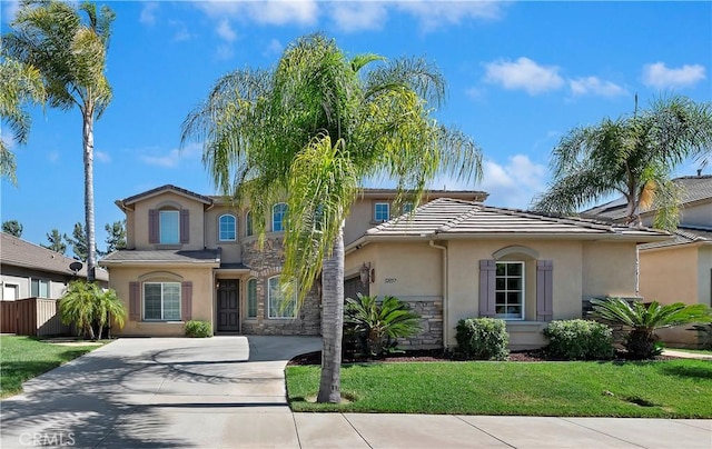 mediterranean / spanish-style home featuring a front lawn