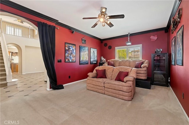 carpeted living room featuring ceiling fan and ornamental molding