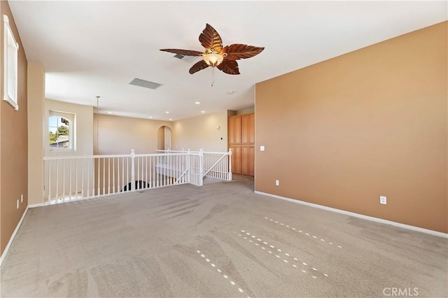 spare room with light colored carpet and ceiling fan