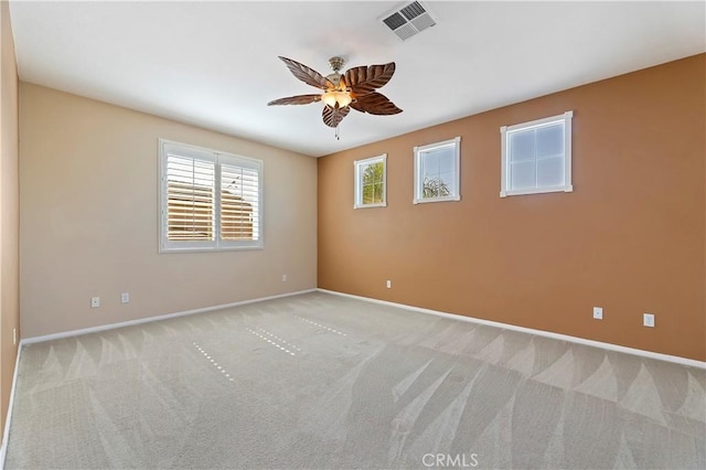 spare room featuring light carpet and ceiling fan