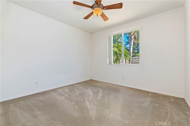 unfurnished room featuring ceiling fan and light carpet