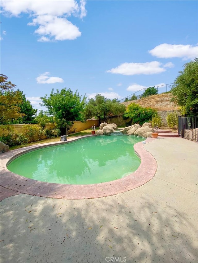 view of swimming pool with fence and a fenced in pool