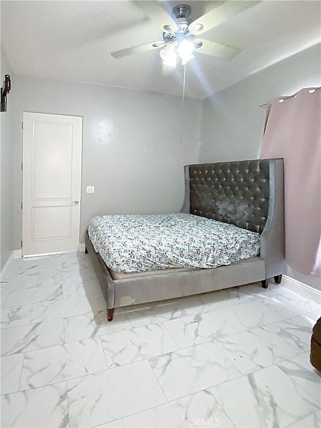 bedroom with marble finish floor, ceiling fan, and baseboards