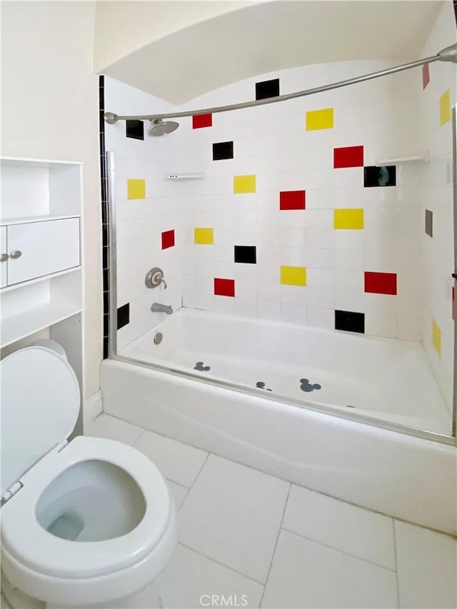 bathroom with tub / shower combination, toilet, and tile patterned floors