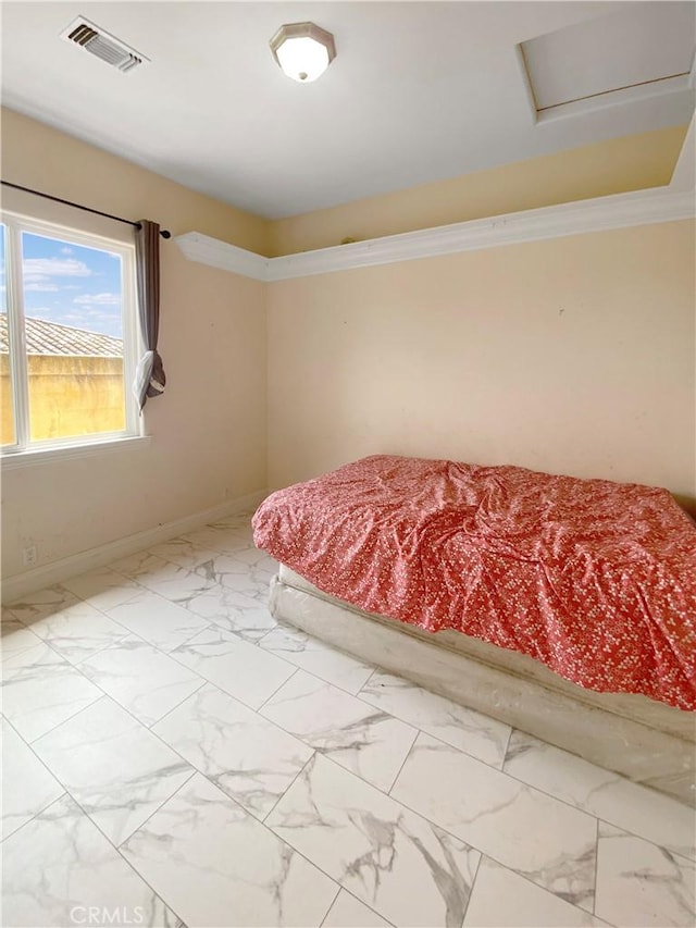 unfurnished bedroom with attic access, visible vents, baseboards, marble finish floor, and crown molding