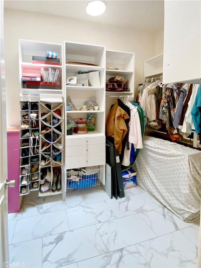 spacious closet with marble finish floor