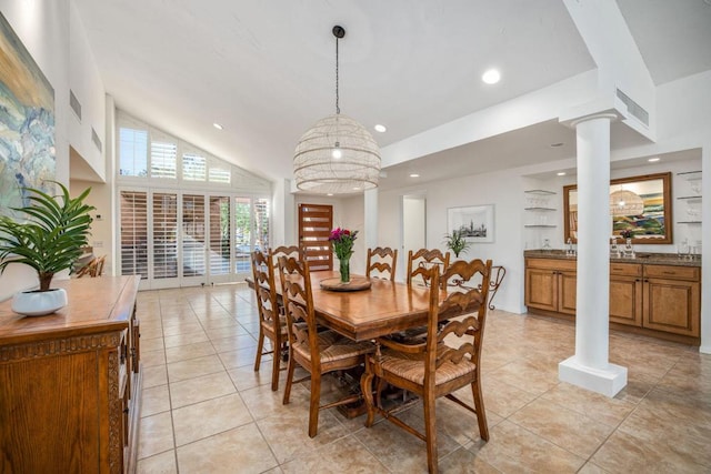 tiled dining room with ornate columns and high vaulted ceiling