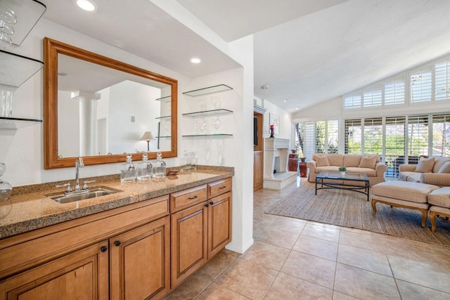 bathroom featuring tile patterned flooring, vanity, and lofted ceiling